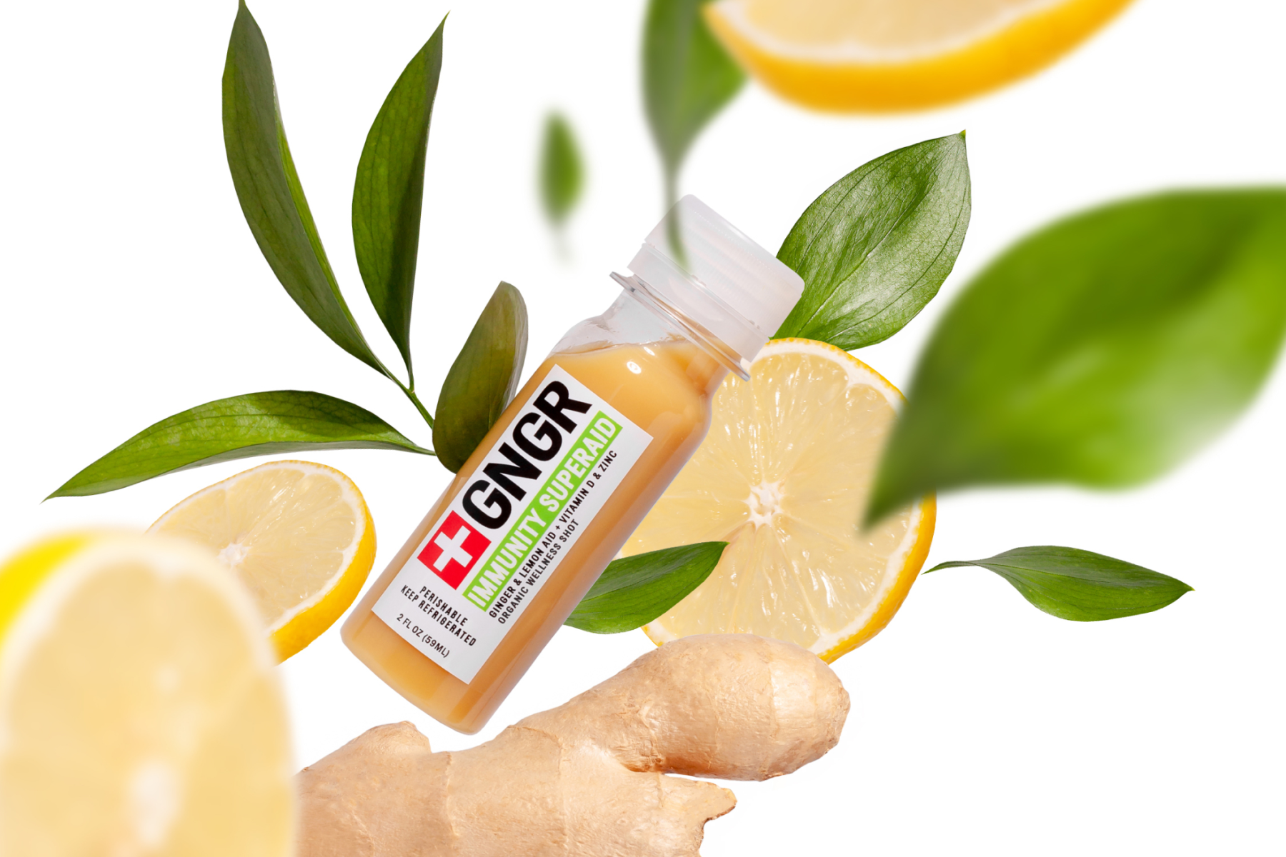 GNGR Immunity Superfood bottle with fresh lemon slices, green leaves, and ginger on a white background for wellness and health.
