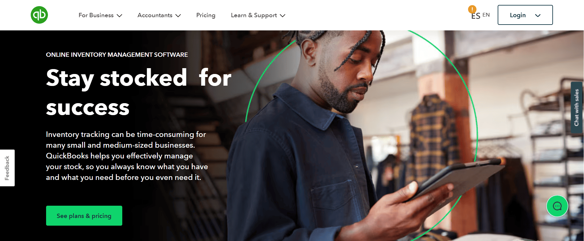A man with braids uses a digital tablet in a warehouse showing QuickBooks CRM inventory management and plans & pricing button.